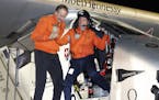Bertrand Piccard, right, and Andre Borschberg, left, the pilots of the Solar Impulse 2 plane, celebrate in Abu Dhabi, United Arab Emirates, Tuesday, J