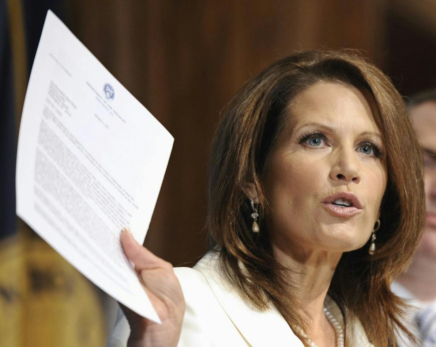 Republican presidential candidate, Rep. Michele Bachmann, R-Minn., displays a January 6, 2011 letter from Treasury Secretary Timothy Geithner to Senate Majority Leader Harry Reid expressing Geithner concerns about the nation's debt limit, during an address at the National Press Club in Washington, Thursday, July 28, 2011.