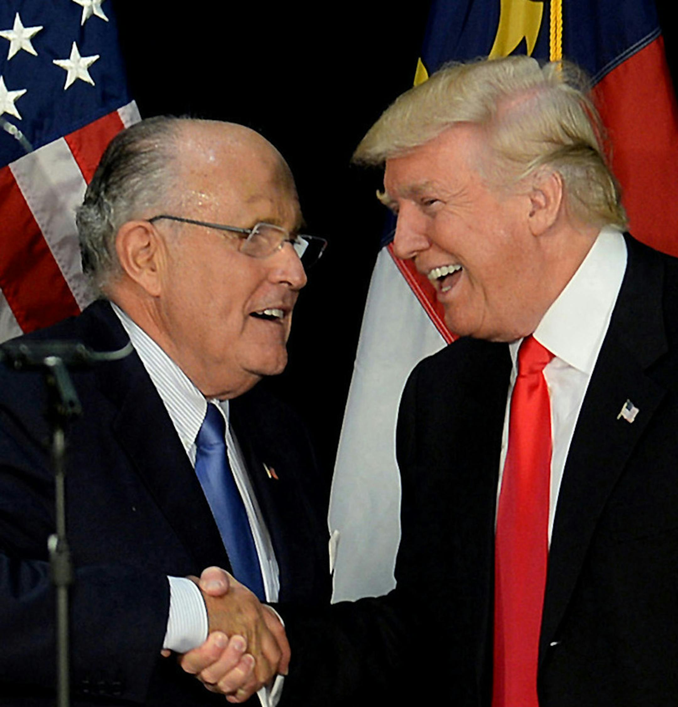 Former New York City mayor Rudy Giuliani, left, welcomes then-Republican presidential candidate Donald Trump on stage during a campaign rally on August 18, 2016, at the Charlotte Convention Center in Charlotte, N.C. (Jeff Siner/Charlotte Observer/TNS)