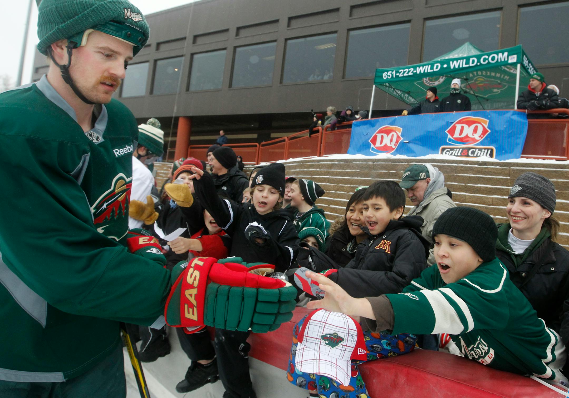 Kyle Brodziak gave away signed pucks at the John Rose Speedskating Oval in Roseville, where the Wild held an outdoor practice Sunday. The Wild has expressed interest in hosting an outdoor NHL game.