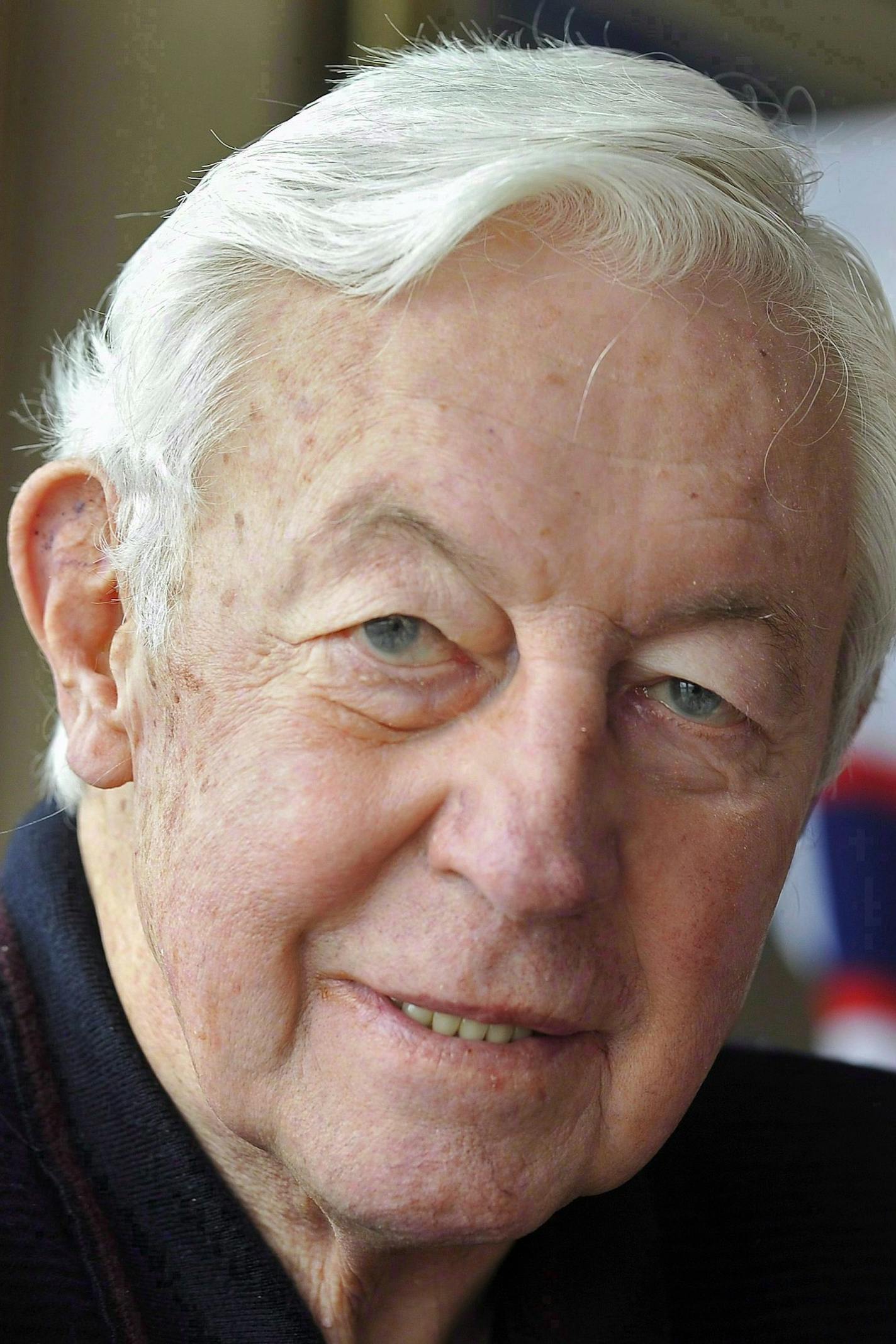 FILE - In this Nov. 25, 2009, file photo, Montreal Canadiens great Jean Beliveau poses at his home in St. Lambert, Quebec. Beliveau died Tuesday, Dec. 2, 2014. He was 83. The team confirmed the death of the Hall of Fame center and one of the most beloved players in Canadiens history. (AP Photo/The Canadian Press, Graham Hughes, File)