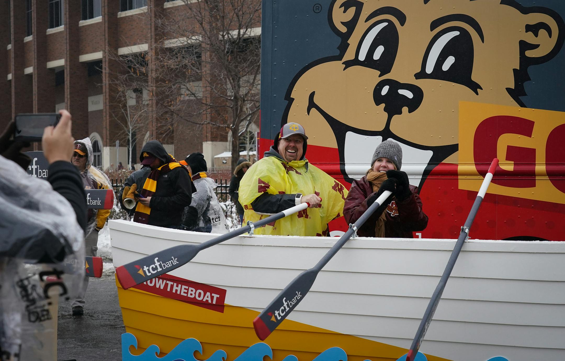 Fans braved the rain and snow to tailgate before the Gophers hosted the Badgers in the 2019 battle for Paul Bunyan's Axe on Saturday, Nov. 30.
Jason Erickson from Eagan and Kris Wihlm from Minnetonka got their photo taking 'rowing the boat' before the game. "We've been standing outside forever," Wihlm said. "I needed to row to warm up." ] Shari L. Gross &#x2022; shari.gross@startribune.com We spend Saturday -- before, during and after the contest for Paul Bunyan's Axe -- chronicling the sights,