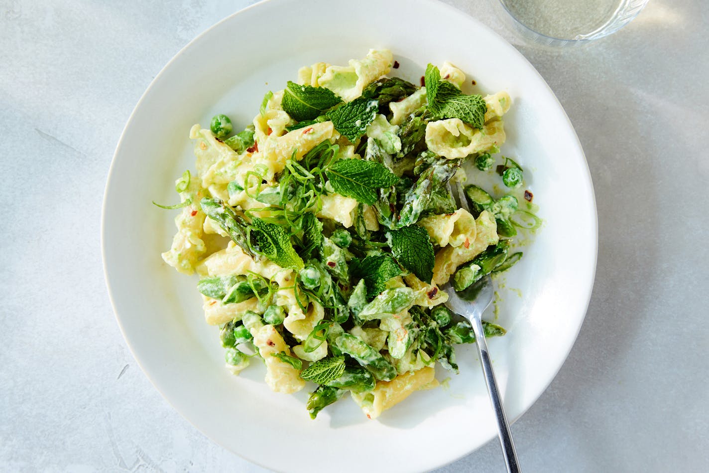 Asparagus-feta pasta in New York, May 4, 2023. Yogurt and feta make this asparagus pasta light and springy, piquant and creamy. Food styled by Maggie Ruggiero. (Ryan Liebe/The New York Times)