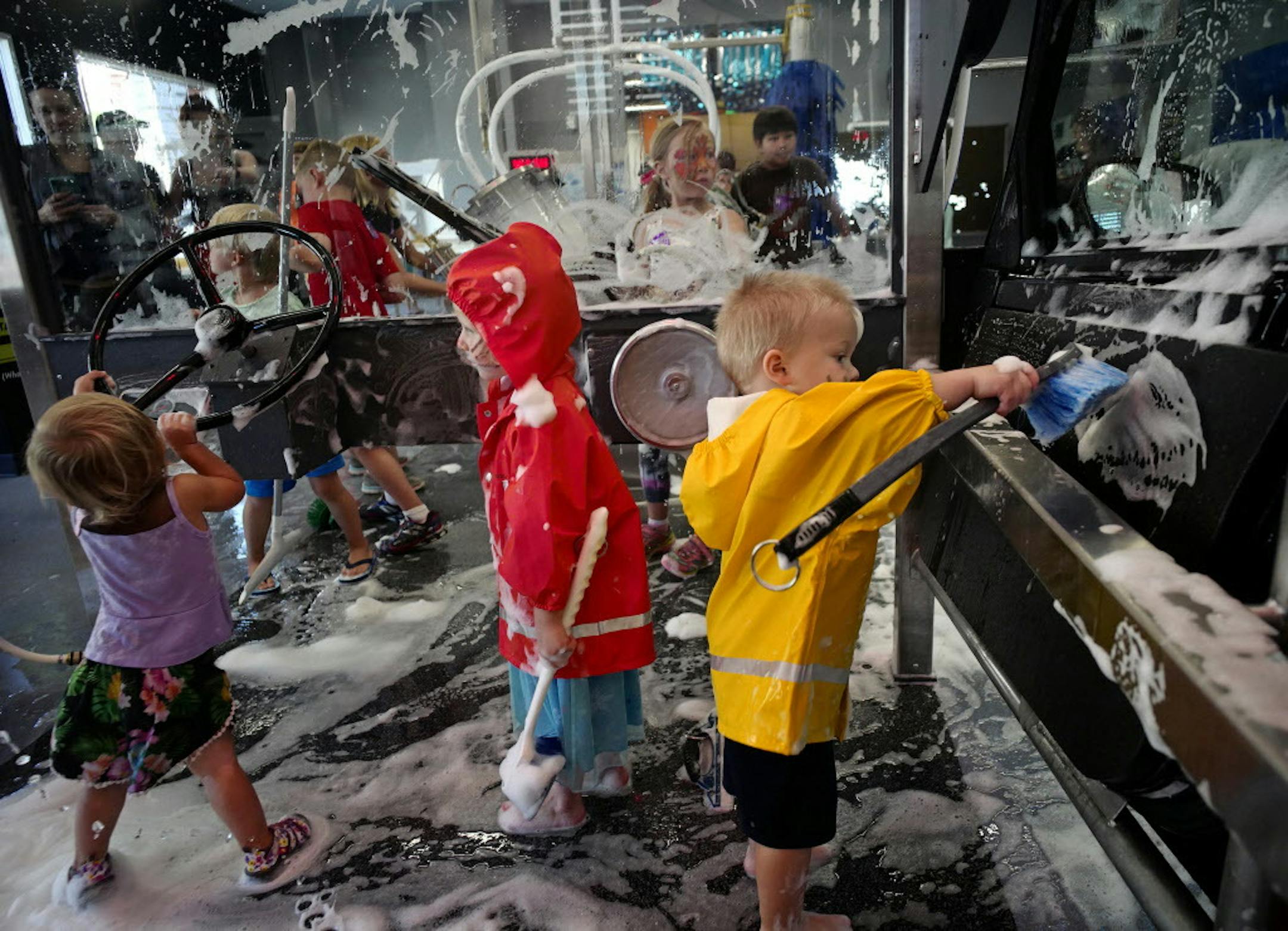 In August 2016, Croix Xavier, far right, of Richmond, Wisconsin, got a kick out of the the car wash.