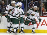 Minnesota Wild left wing Zach Parise, right, celebrates after scoring a goal against the Colorado Avalanche in the second period of an NHL hockey game