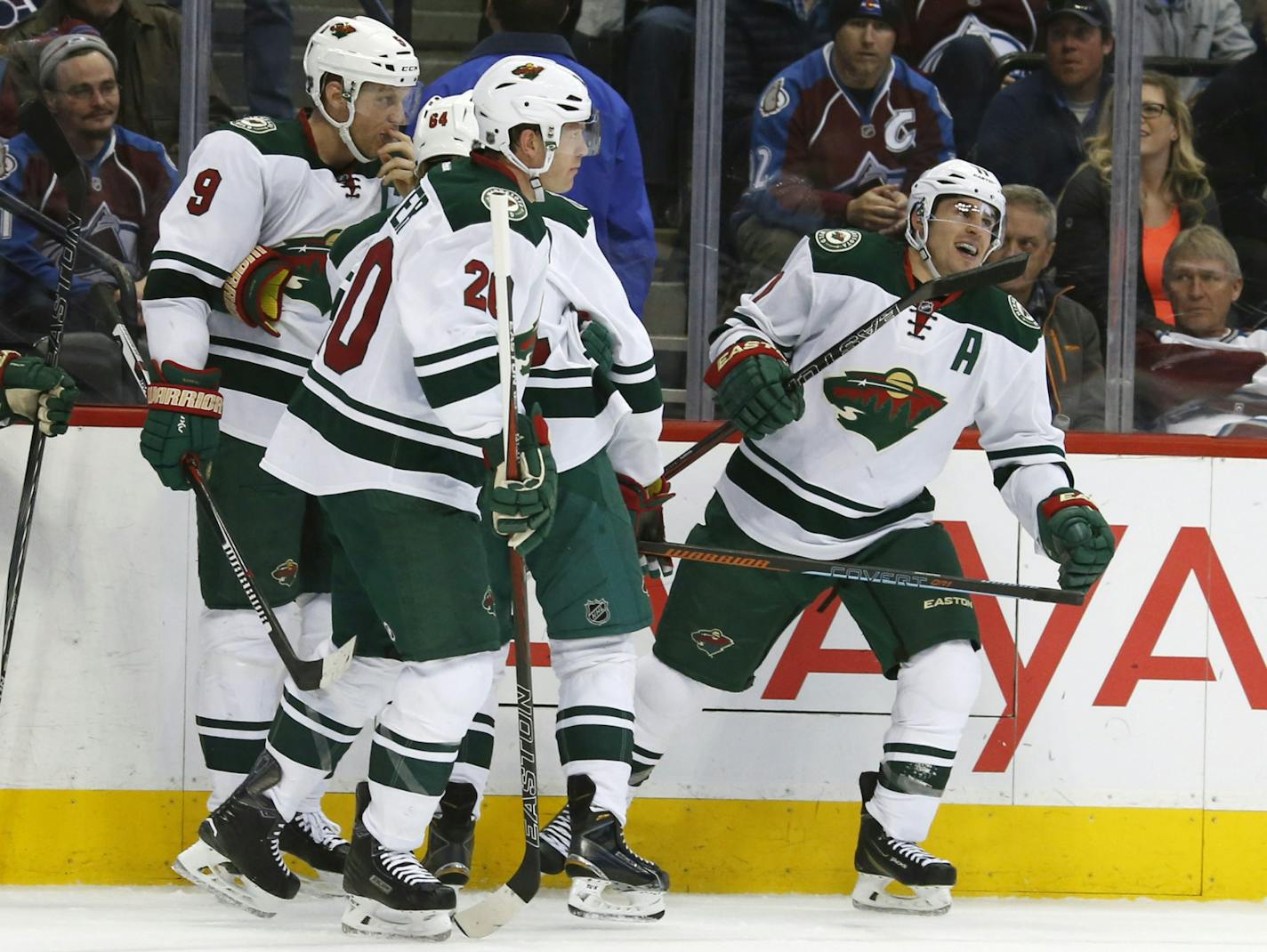 Minnesota Wild left wing Zach Parise, right, celebrates after scoring a goal against the Colorado Avalanche in the second period of an NHL hockey game Saturday, March 26, 2016, in Denver.