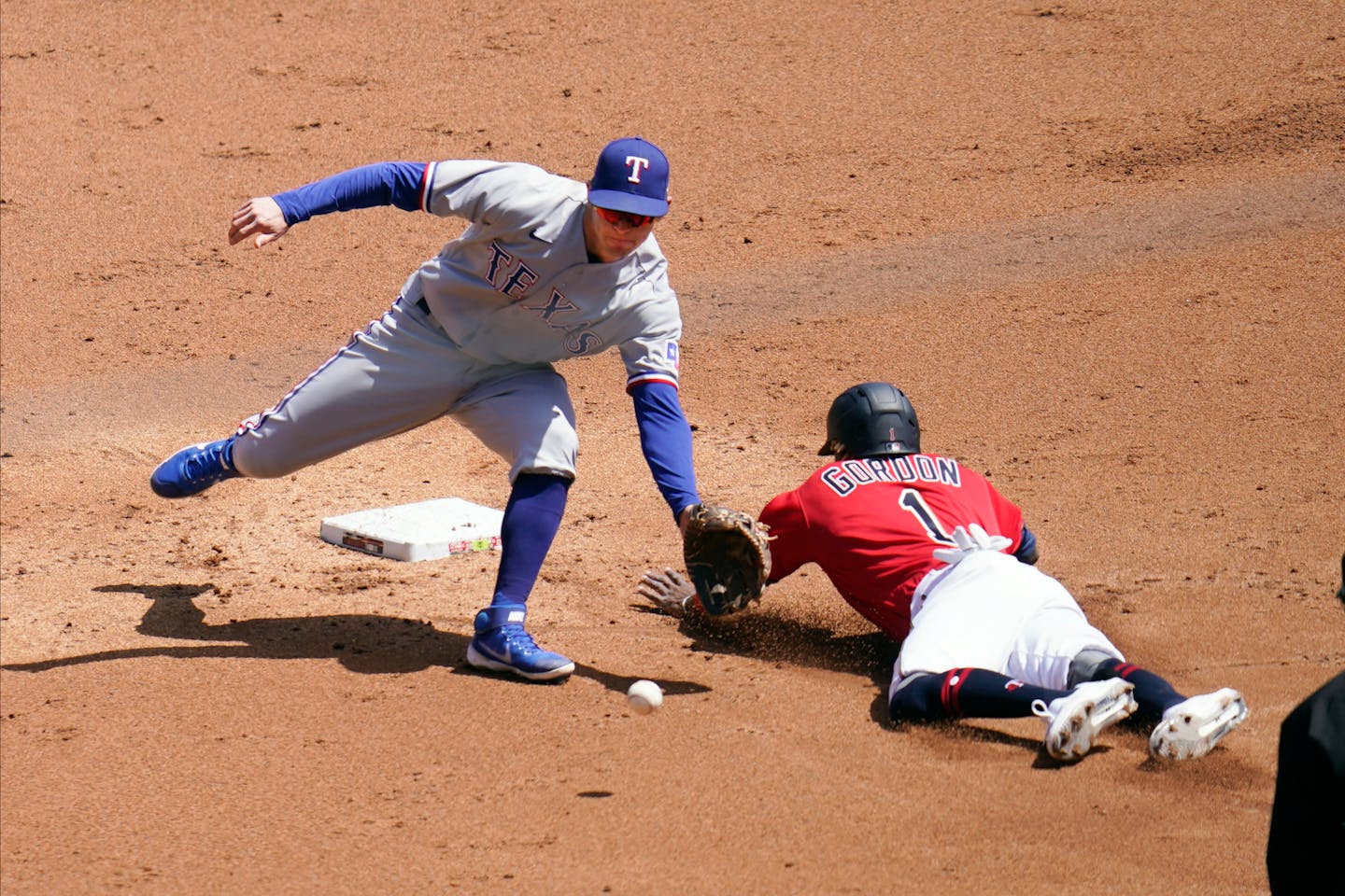 Minnesota Twins' Nick Gordon, right, steals second base as the throws gets past Texas Rangers second baseman Nick Solak in the second inning of a baseball game, Thursday, May 6, 2021, in Minneapolis. (AP Photo/Jim Mone)