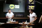 New England Patriots tight end Rob Gronkowski (left) takes Buffalo Wild Wings' Blazin Challenge with his brother Dan (right).