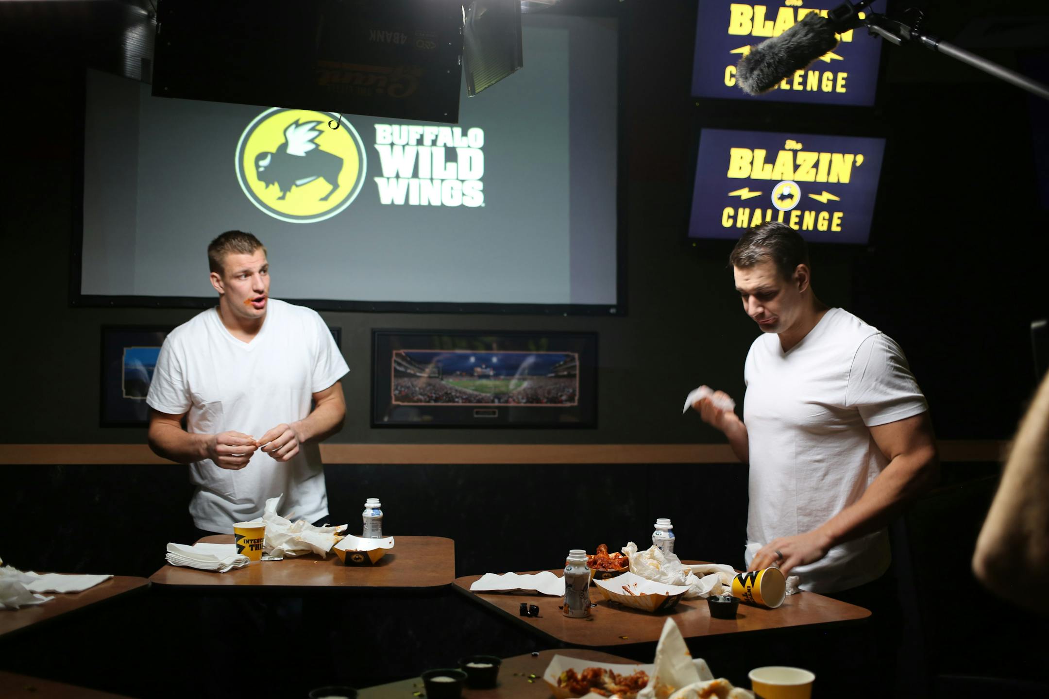 New England Patriots tight end Rob Gronkowski (left) takes Buffalo Wild Wings' Blazin Challenge with his brother Dan (right).