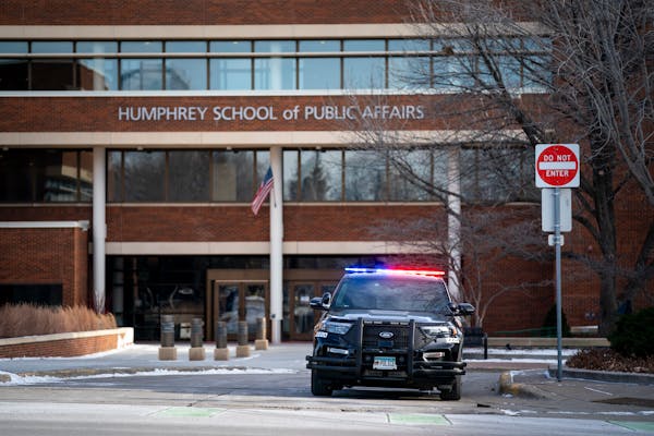 A police car waits on campus at the University of Minnesota after receiving deadly threats by a man saying he was going to target the U on Thursday, J