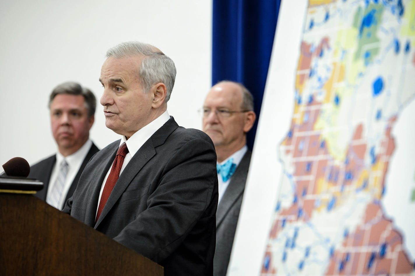 Governor Mark Dayton announced a $220 million plan to protect water quality andf modernize Minnesota's aging water infrastructure. The map shows how many streams and rivers are compromised and unsafe for swimming and recreation. Behind him are Minnesota Public Facilities Director Jeff Freeman and health Commissioner Edward Ehlinger. ] GLEN STUBBE * gstubbe@startribune.com Thursday, January 14, 2015 Governor Mark Dayton announced a $220 million plan to protect water quality andf modernize Minneso