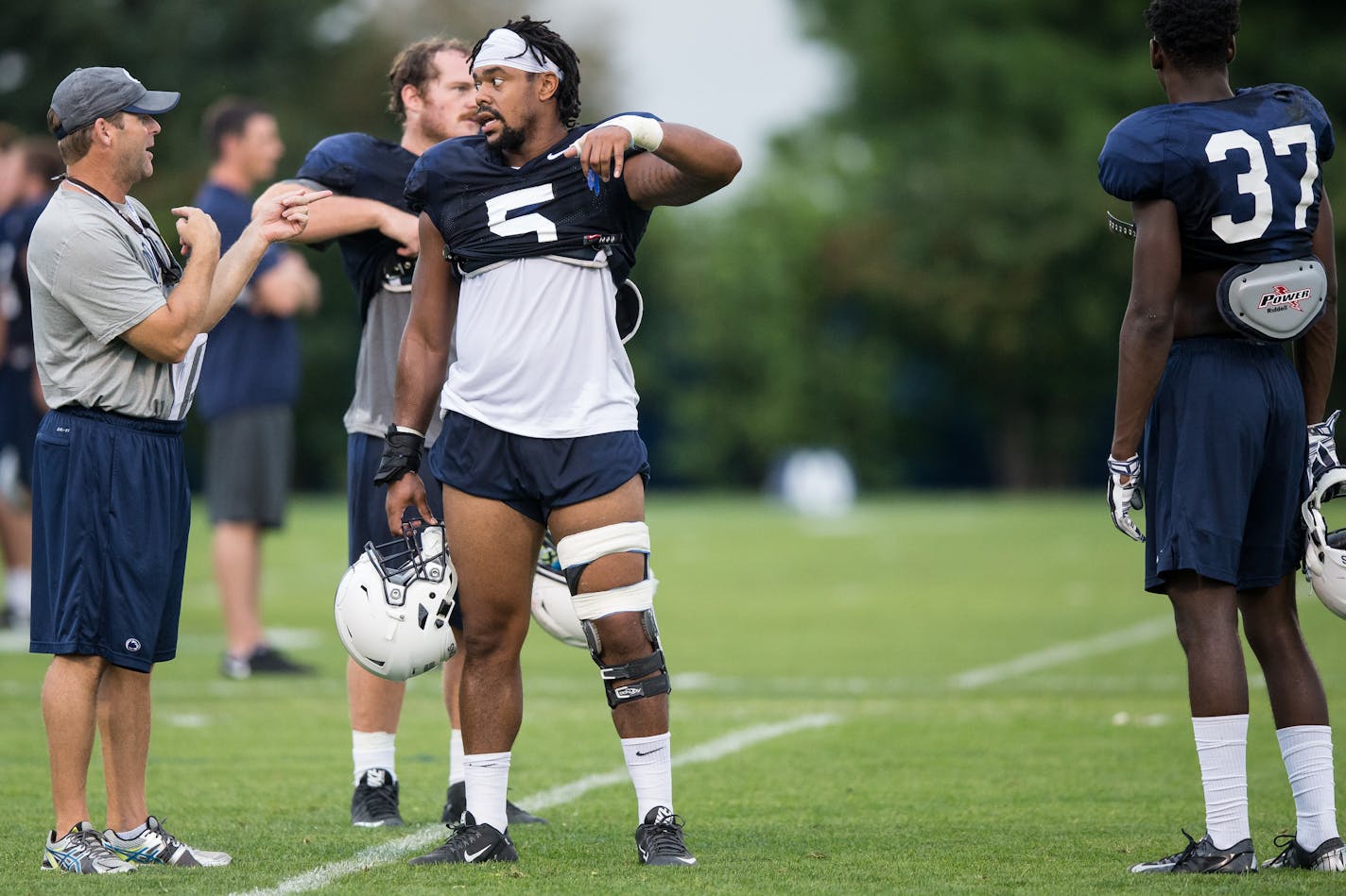 Penn State defensive coordinator Brent Pry talks with linebacker Nyeem Wartman-White during the NCAA college football team's practice Wednesday, Aug. 31, 2016, in State College, Pa. (Joe Hemitt/PennLive.com via AP)