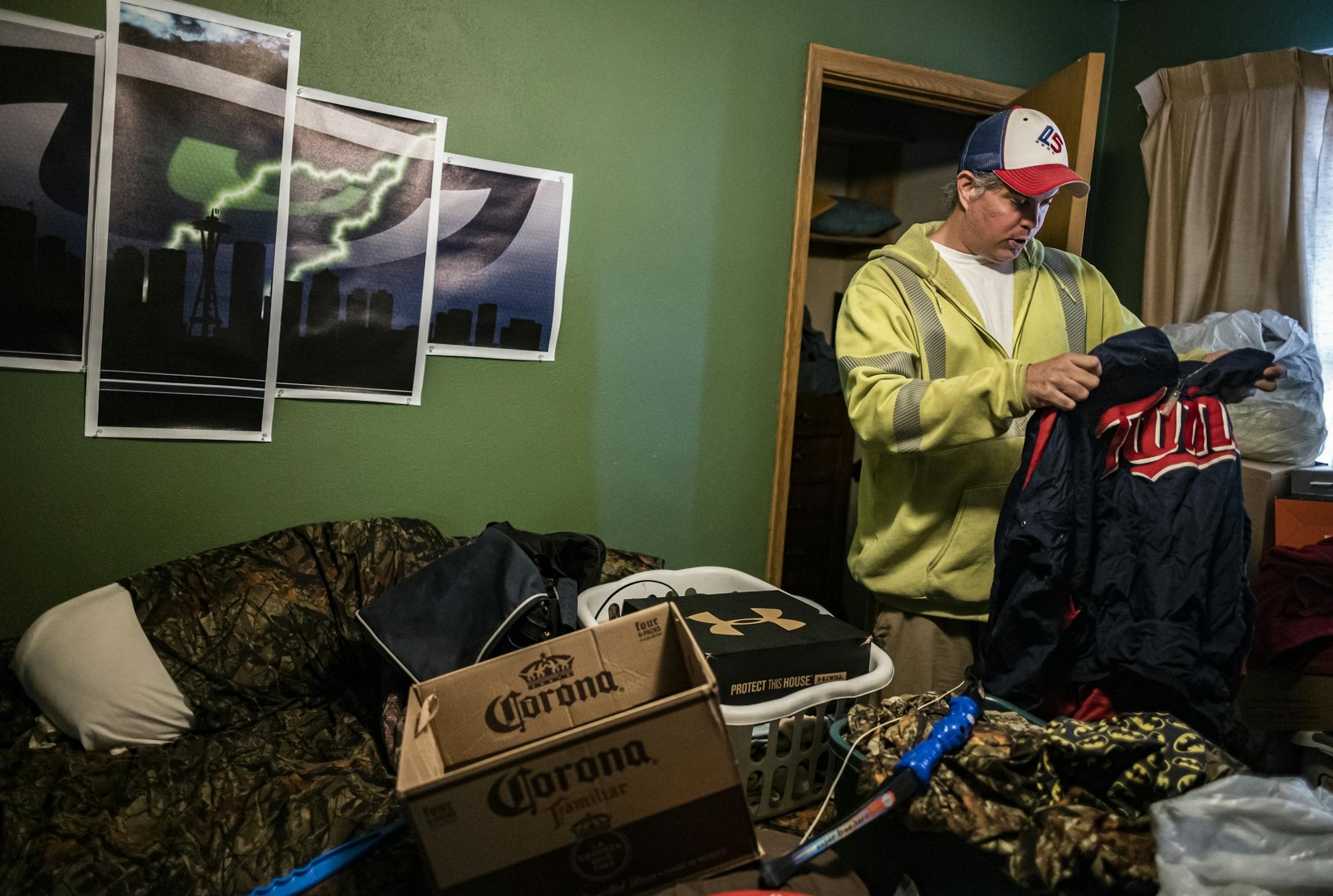 Tracey Roberts packed some of his sports team wear in his South St. Paul apartment unit. He has to move out by the end of March. He feels hard-pressed to find a similar one bedroom apartment for $650.