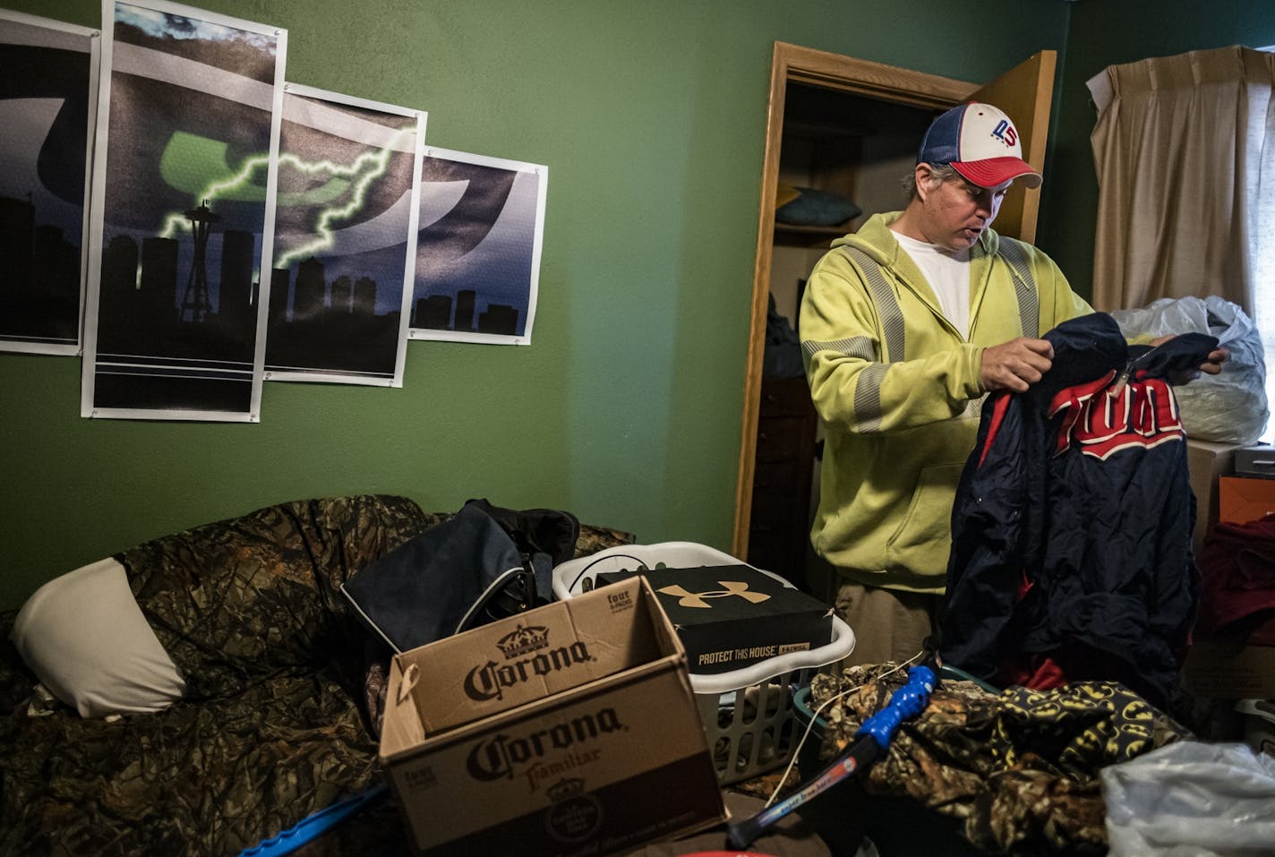 Tracey Roberts packed some of his sports team wear in his South St. Paul apartment unit. He has to move out by the end of March. He feels hard-pressed to find a similar one bedroom apartment for $650.