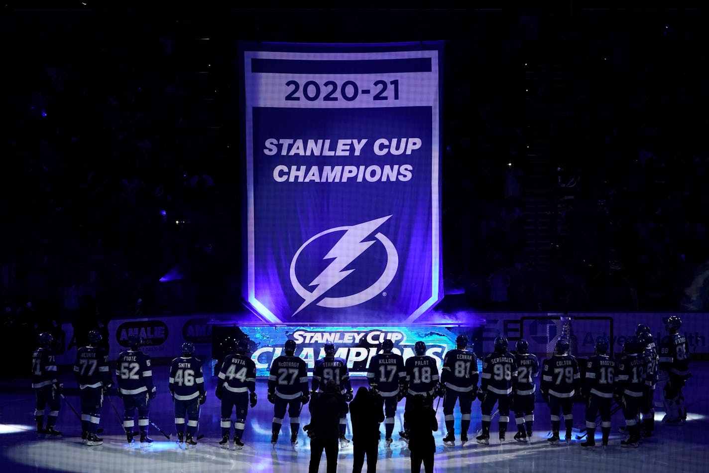 The Tampa Bay Lightning raise their 2020-2021 Stanley Cup Champions banner before an NHL hockey game against the Pittsburgh Penguins Tuesday, Oct. 12, 2021, in Tampa, Fla. (AP Photo/Chris O'Meara)