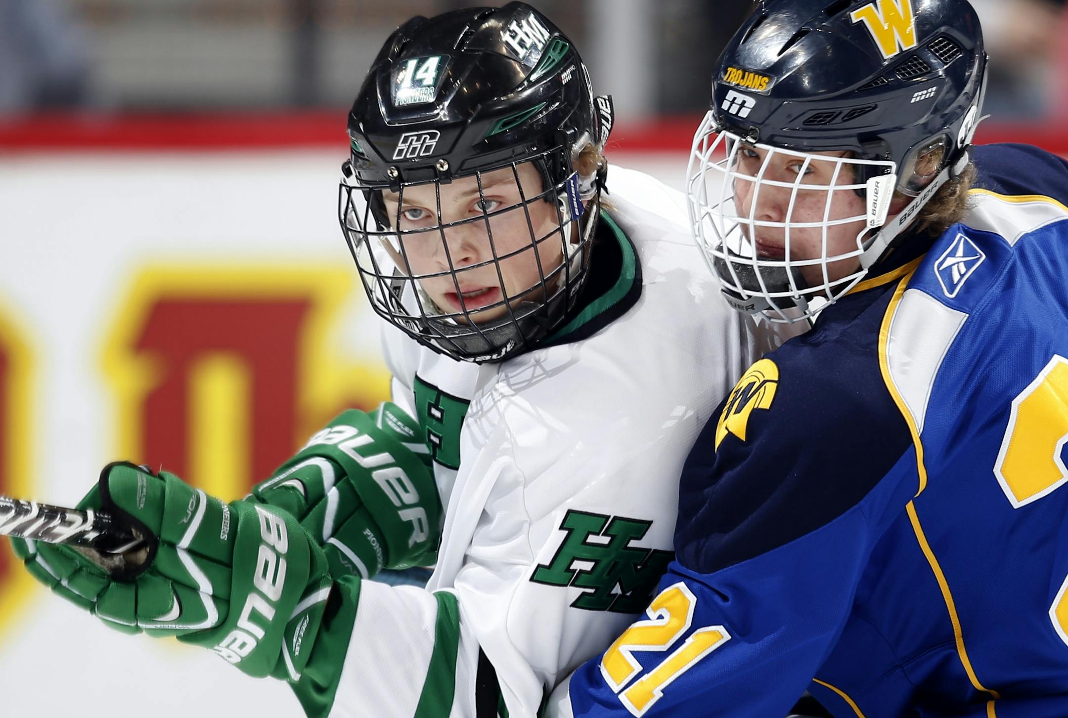 Zach Mills (14) of Hill Murray and Jack Sorensen (21) of Wayzata tangled up in the first period.