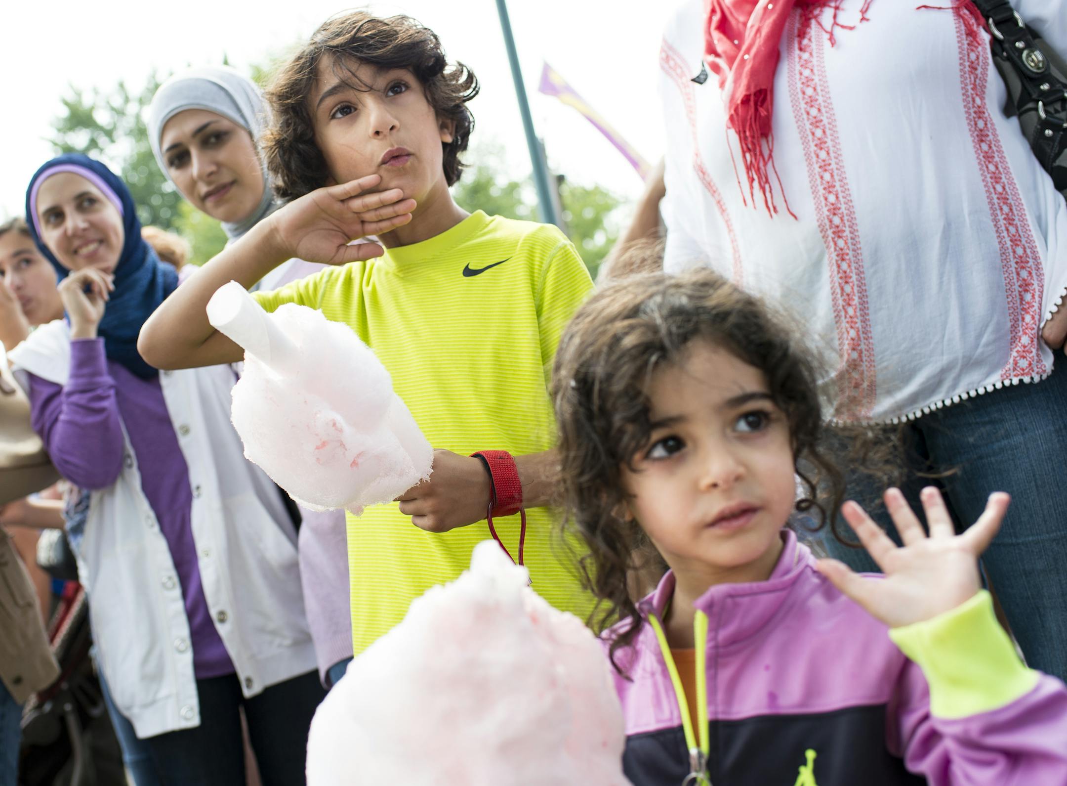 Alan Abuhamed, 3, right, and Rayann Shahin, 8, waved to the daily parade procession while eating cotton candy at the Minnesota State Fair Thursday. ] Aaron Lavinsky • aaron.lavinsky@startribune.com The Minnesota State Fair opened Thursday, August 27, 2015 in St. Paul.