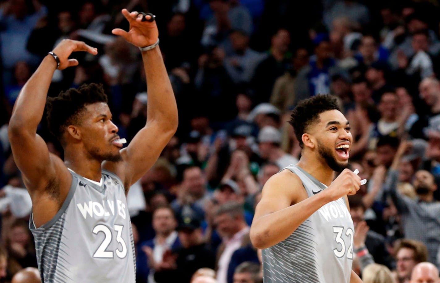 FILE - In this April 11, 2018, file photo, Minnesota Timberwolves' Jimmy Butler, left, Karl-Anthony Towns celebrate in the final seconds as the Timberwolves defeated the Denver Nuggets 112-106 in overtime in an NBA basketball game in Minneapolis. The Timberwolves are in a tricky situation this summer, with needs for more depth, defense and 3-point shooting but no clear-cut ways to acquire any of it. They've got contracts to address with their two All-Stars, too, in Karl-Anthony Towns and Jimmy Butler. (AP Photo/Jim Mone, File)