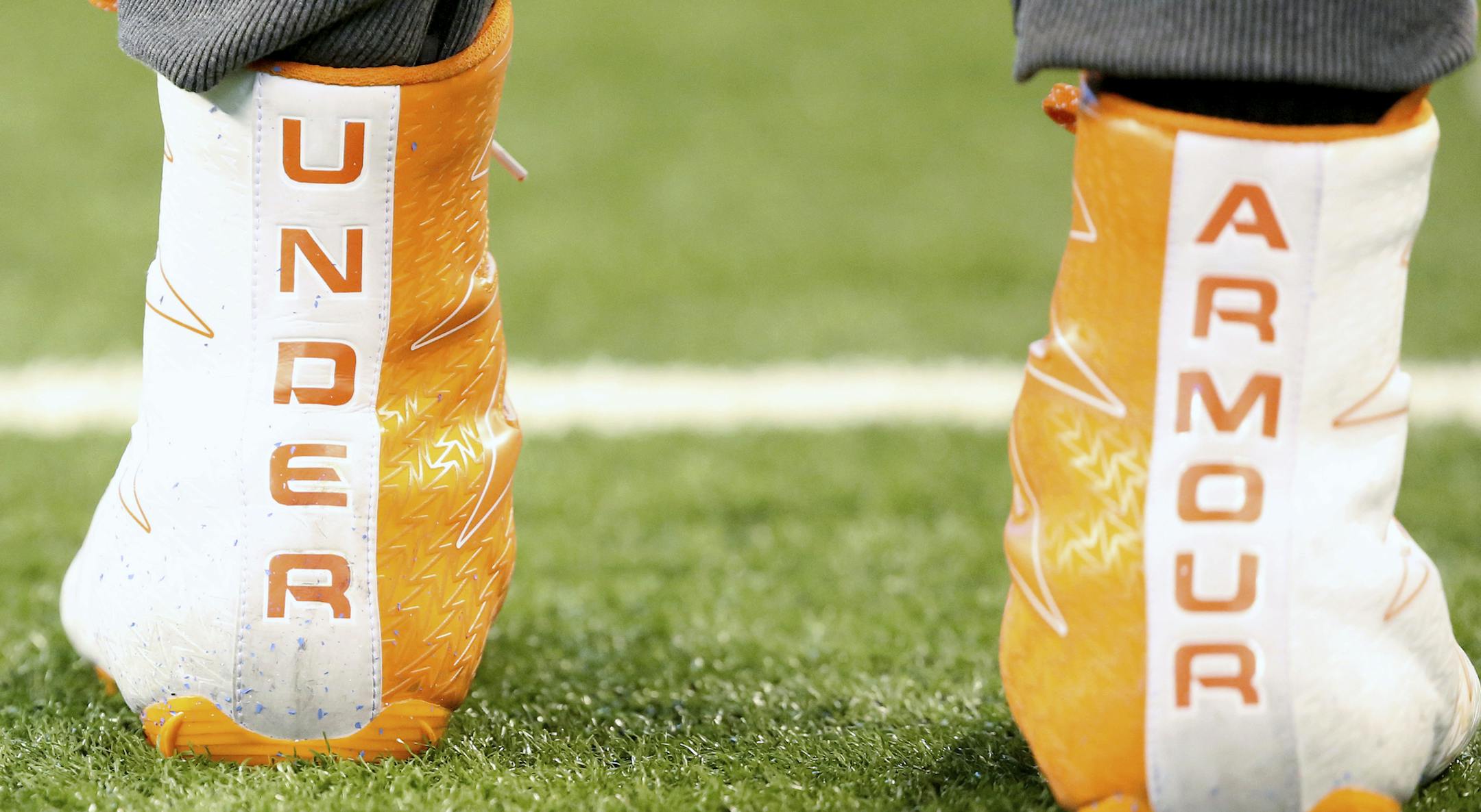 FILE- This March 5, 2017, file photo shows a closeup of Under Armour cleats are seen before a drill at the 2017 NFL football scouting combine in Indianapolis. Under Armour reports earnings Tuesday, May 1, 2018. (AP Photo/Gregory Payan, File)