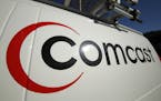 This Feb. 11, 2011 file photo shows the Comcast logo on one of the company's vehicles, in Pittsburgh.