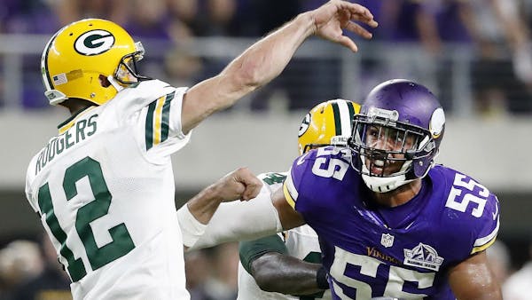 Anthony Barr chases Packers quarterback Aaron Rodgers during a game last season.