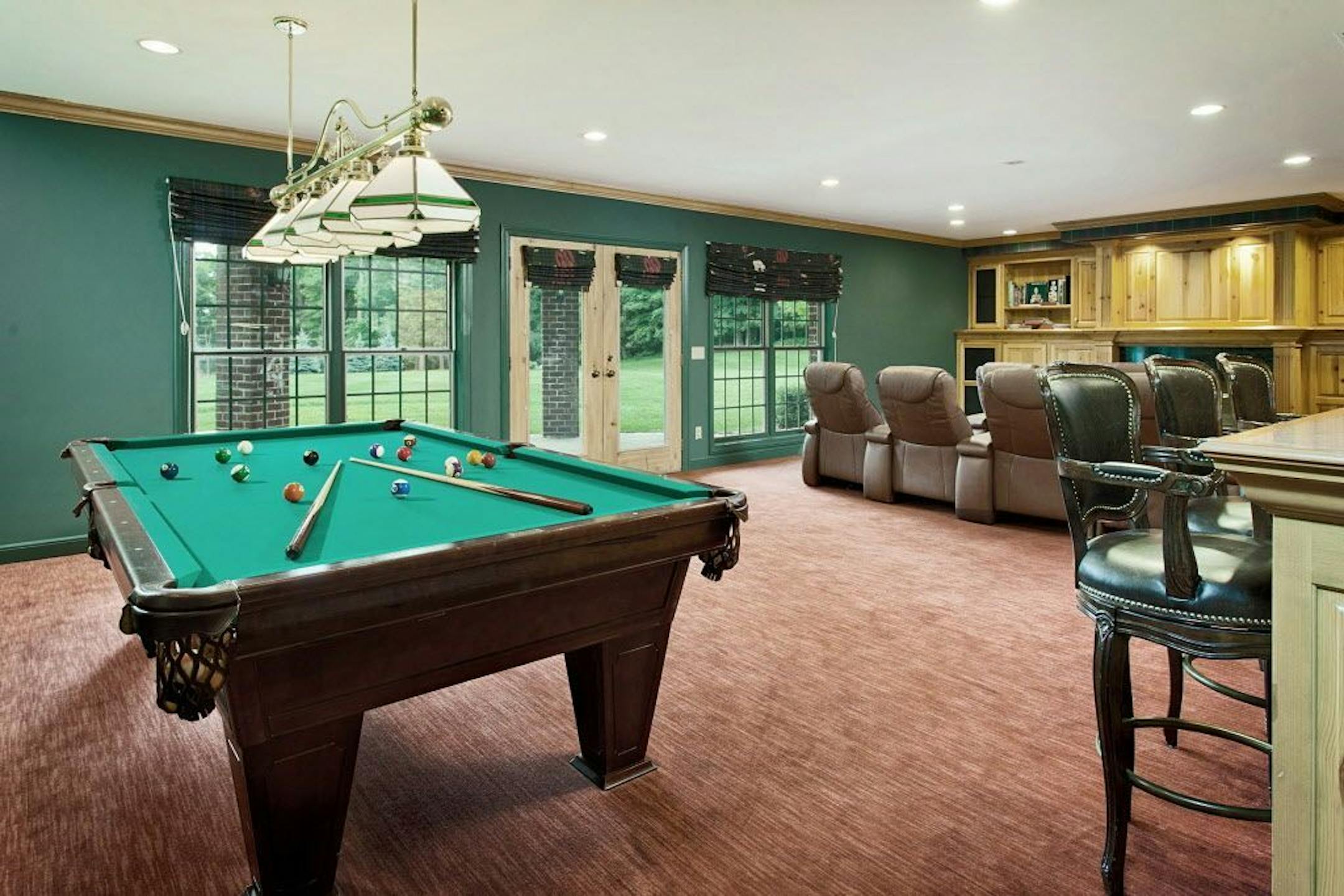 The walkout lower level features a game room, TV/theater area, wet bar, and wine cellar.