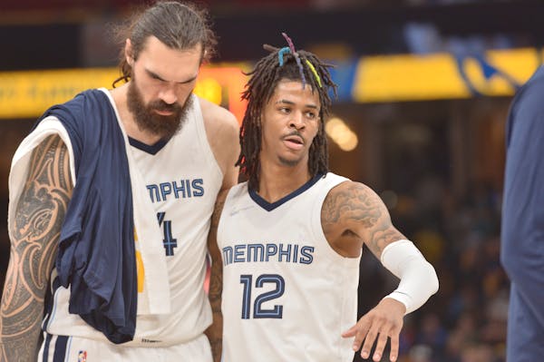 Memphis Grizzlies center Steven Adams (4) and guard Ja Morant (12) stand on the court iduring the second half of Game 1.