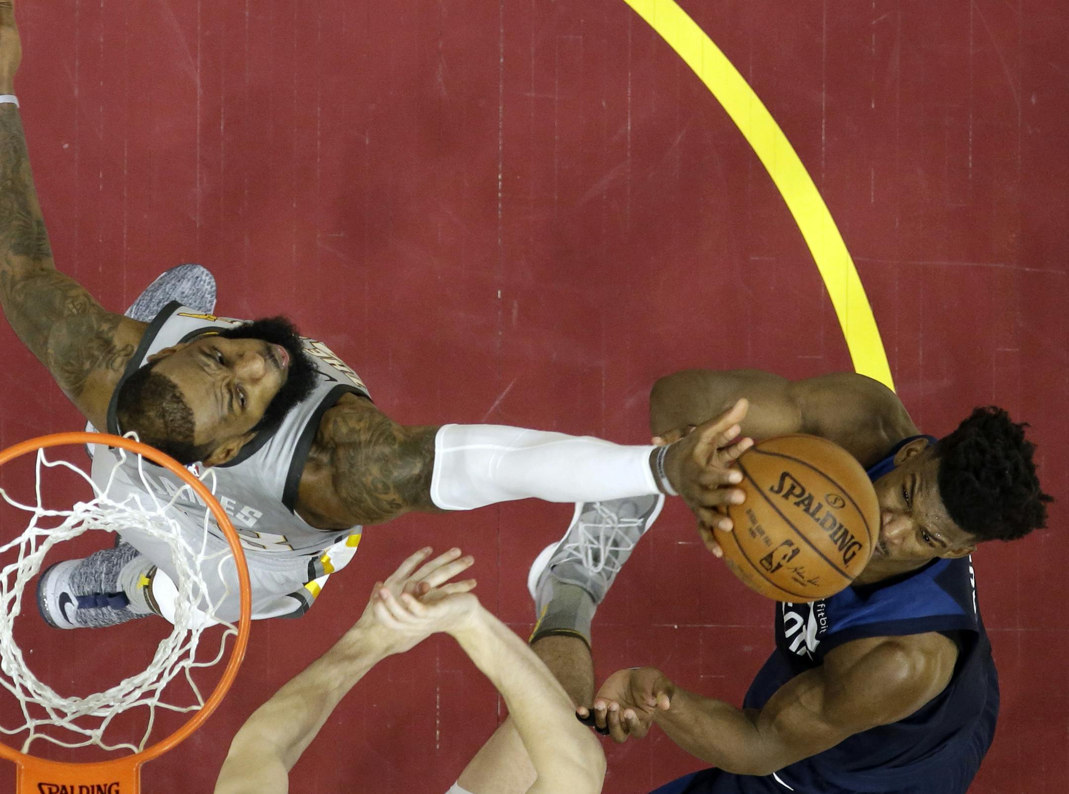 FILE - In this Feb. 7, 2018, file photo, Cleveland Cavaliers' LeBron James, left, blocks a shot by Minnesota Timberwolves' Jimmy Butler in overtime during an NBA basketball game in Cleveland. The Cavaliers won 140-138 in overtime. Moments after blocking Butler&#x2019;s potential game-winning shot with 1.3 seconds left, James caught a long inbounds pass from Jeff Green, created some space from Butler near the foul line and sank a shot that ended Cleveland&#x2019;s eight-game losing streak on nati