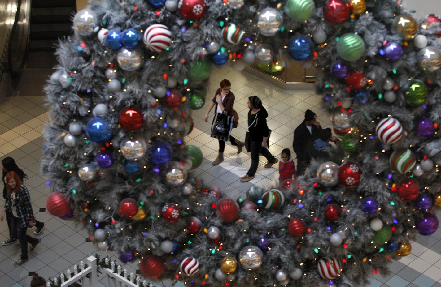 Holiday lights and decorations adorn many of the various shopping areas and levels at the Mall of America. Shoppers were out and about on Friday afternoon, November 18, getting a head start on the upcoming holiday season. The MOA will be among many other retailers this year to open it's doors on Black Friday at midnight instead of the past, traditional 6 a.m. starting time. More than 100 retailers open at midnight on Black Friday at the MOA, including Macy's, Hot Topic, Forever 21, H&M, and Amer