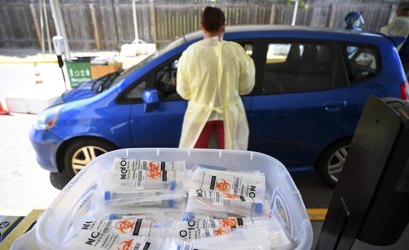 COVID-19 testing kits in a plastic bin at North Memorial Health's drive-up testing facility in Robbinsdale Wednesday. ] aaron.lavinsky@startribune.com Healthcare workers tested drive-up and walk-up patients for COVID-19 behind the North Memorial Health Specialty Center on Wednesday, July 29, 2020 in Robbinsdale, Minn.