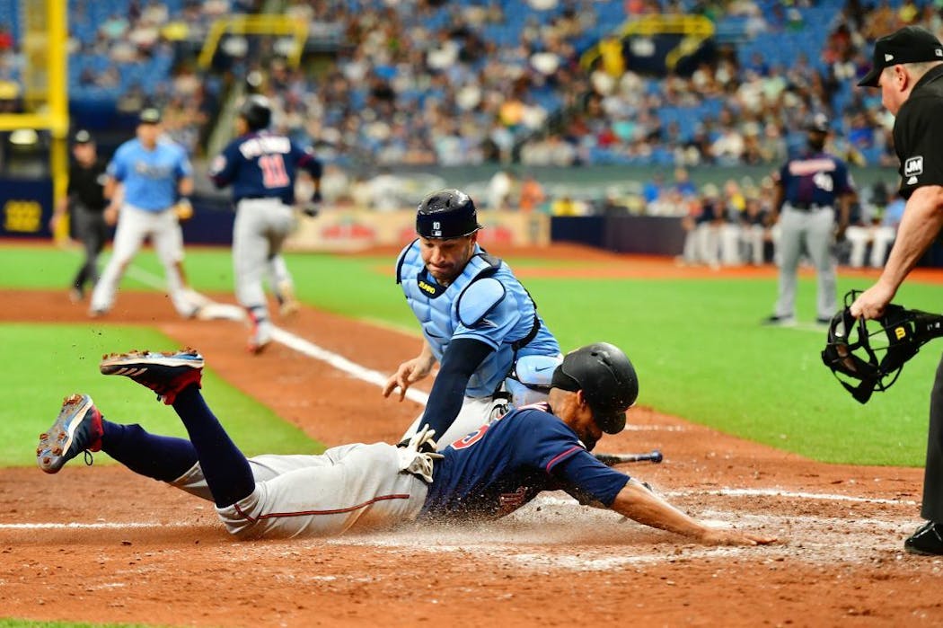Byron Buxton slides home safe after Jorge Polanco (11) bunts off of Ryan Yarbrough (48) of the Tampa Bay Rays during the fifth inning.