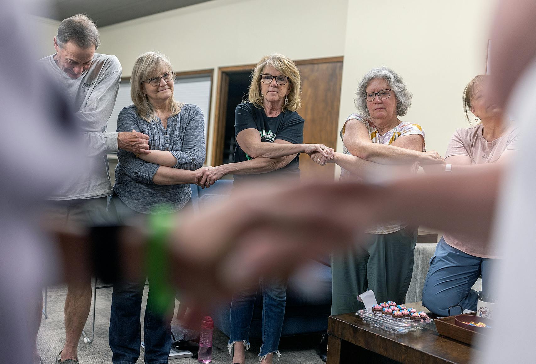 Pam Lanhart joined hands with others as they called out their loved ones' names. “We are all not in the same boat, but we are in the same ocean,” said Lanhart.