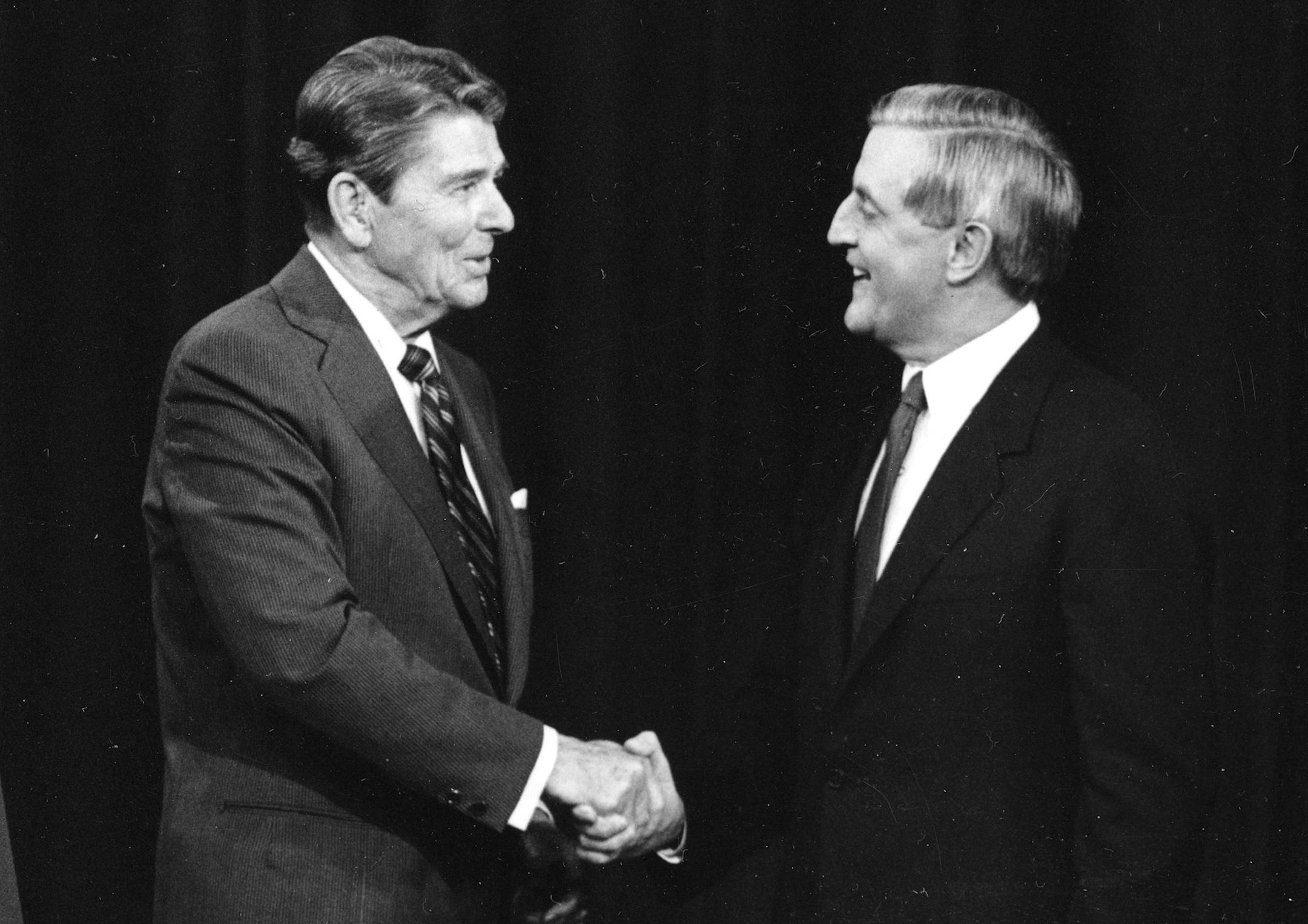 FILE - In this Oct. 22, 1984, file photo, President Ronald Reagan, left, and his Democratic challenger Walter Mondale, shake hands prior to their televised presidential debate, in Kansas City, Mo. When Reagan won the White House in 1980, he was 69 _ the oldest man ever elected to the office. During his successful 1984 re-election campaign, he faced questions about his age in his head-to-head contest with 56-year-old Walter Mondale, the former vice president. They spend hours mastering policy. Le