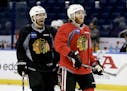 Chicago Blackhawks defenseman Kimmo Timonen, left, right wing Patrick Kane laugh during practice at the NHL hockey Stanley Cup Final, Friday, June 5, 