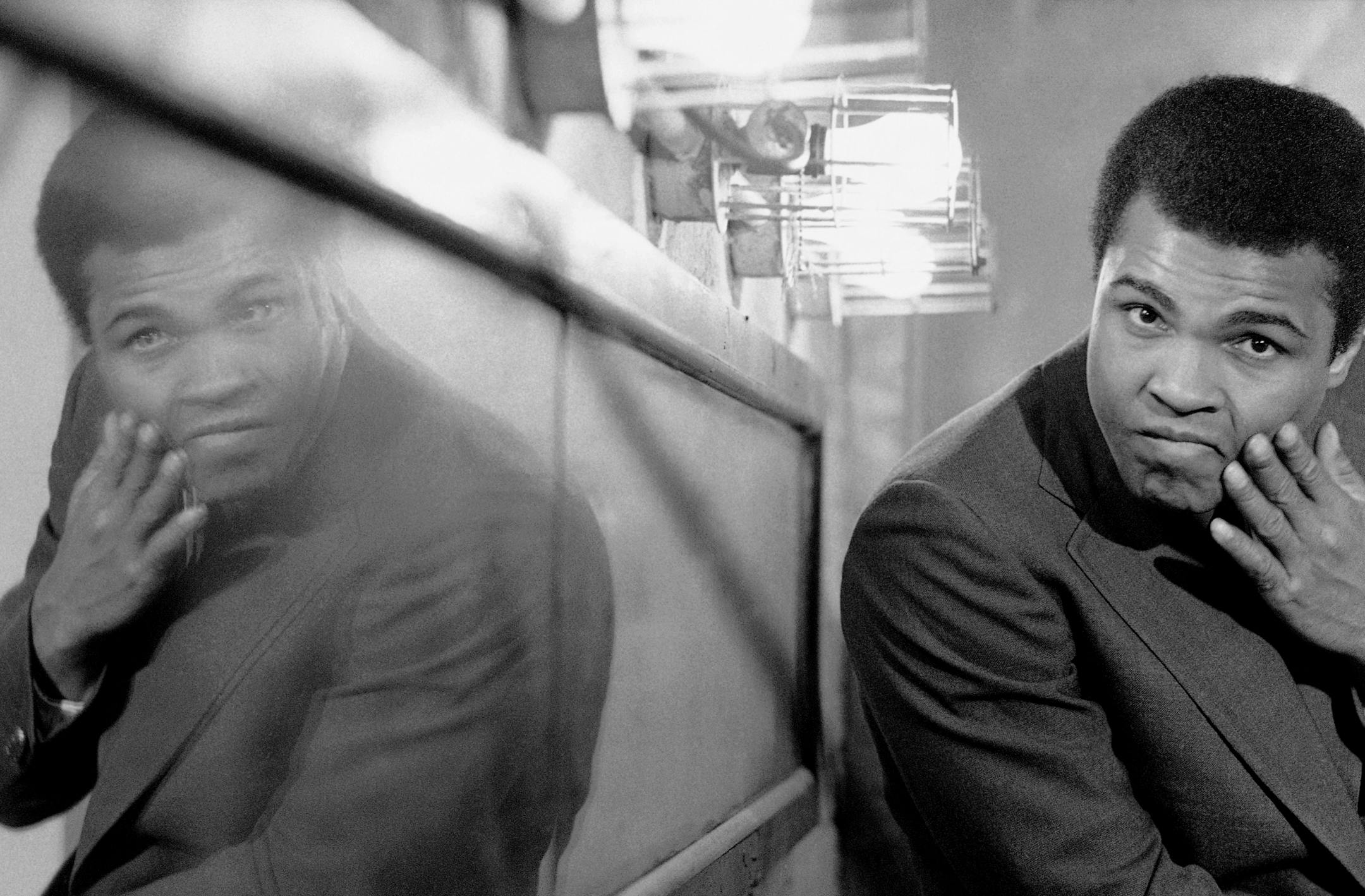 Muhammad Ali rubs his swollen jaw in the dressing room of New York?s Manhattan center on Sunday, March 21, 1971. Ali came to the center to answer questions about his recent title bout with Joe Frazier. (AP Photo/ Ron Frehm) ORG XMIT: APHS284227