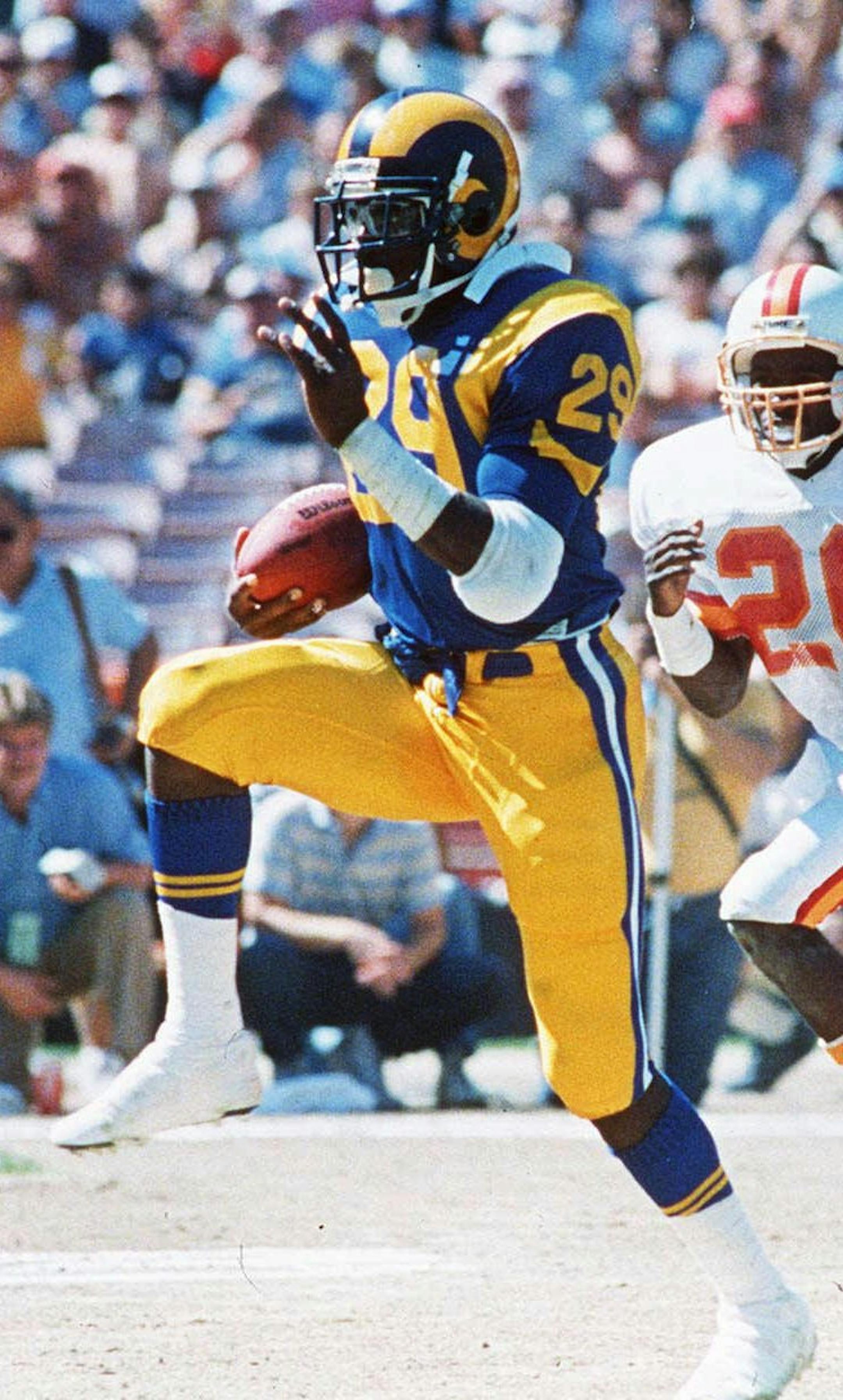 FILE--Los Angeles Rams running back Eric Dickerson breaks away from Tamp Bay Buccaneer defender Ricky Easmon (26) in this Oct. 6, 1986 file photo in Anaheim, Calif. Dickerson is one of 76 nominees for the Pro Football Hall of Fame it was announced Thursday, Oct. 29, 1998. Dickerson, who ran for a record 2,105 yards for the Rams in 1984, stands third on the career rushing list with 13,259 yards and rushed for at least 1,000 yards seven times. Dickerson played for the Rams, Colts and Raiders.(AP P