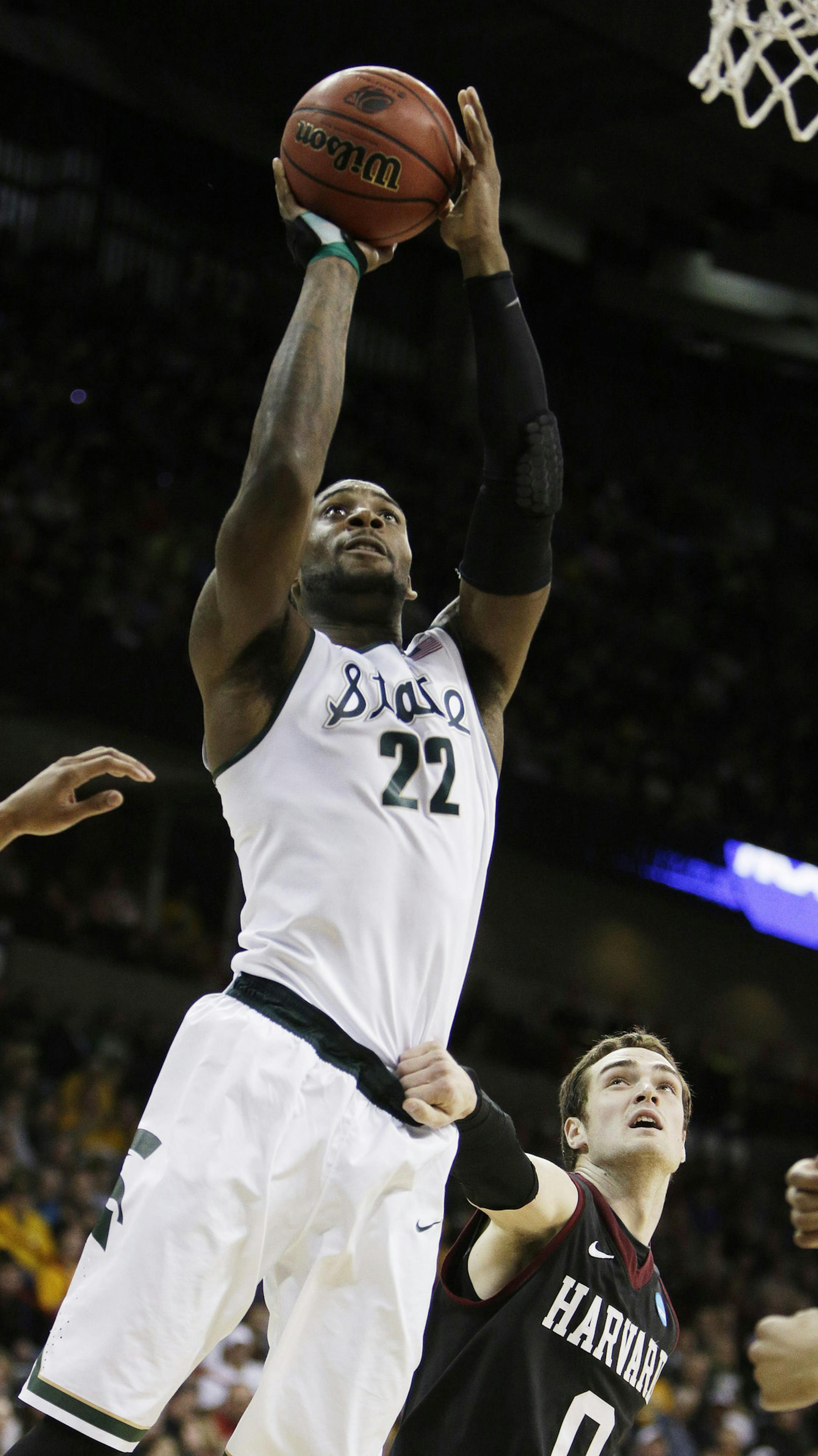 Michigan State’s Branden Dawson (22) shoots a layup against Harvard in the first half during the third-round game of the NCAA men's college basketball tournament in Spokane, Wash., Saturday, March 22, 2014. (AP Photo/Young Kwak)