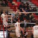 Lakeville South's Aiden Christensen (22), had his attack denied by Osseo's Kirby Schmalz and Cameron Wresh, right, in a tournament game played in Apri