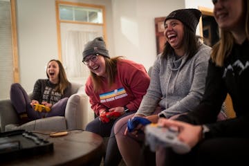 Hannah Justin, Cat Urlich, Aubrey Davis and Lizzie Stenhaug play Mario Kart on Nintendo 64 during game night at Stenhaug’s Golden Valley home on Fri