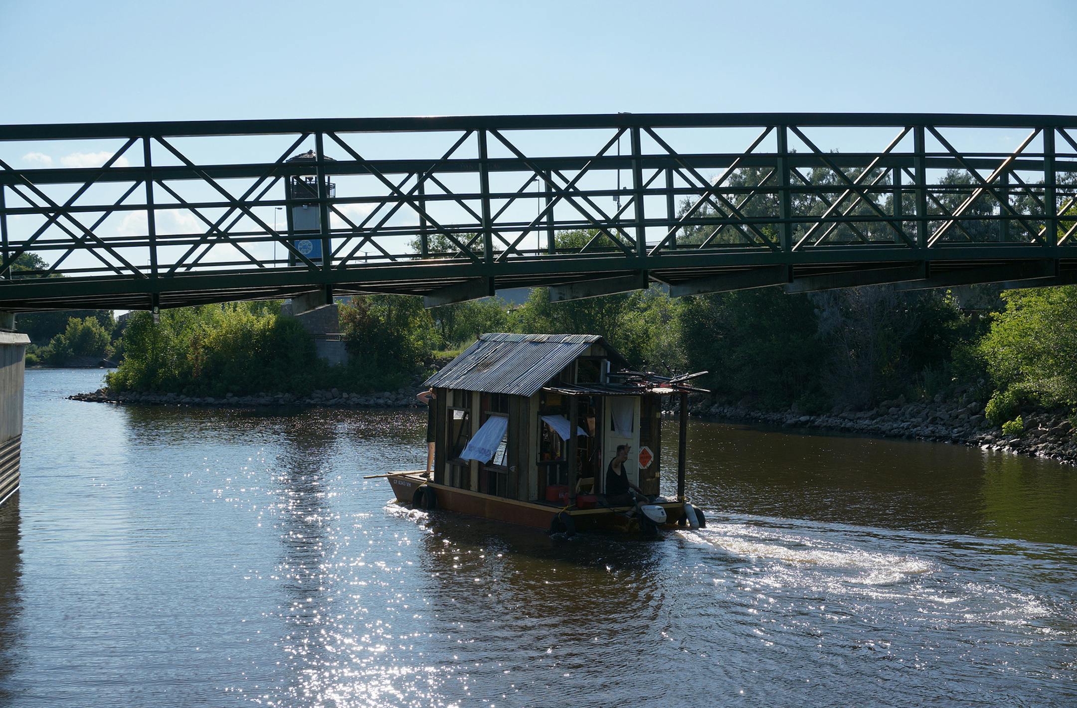Wes Modes, Kai Dalgleish and their dog Hazel are making a month-long trip down the Mississippi River in a shanty boat. They launched from Boom Island Park in Minneapolis on July 26, 2014, and hope to reach Quad Cities, along the Illinois-Iowa border, in a month. Photo by Dylan Peers McCoy, Special to the Star Tribune