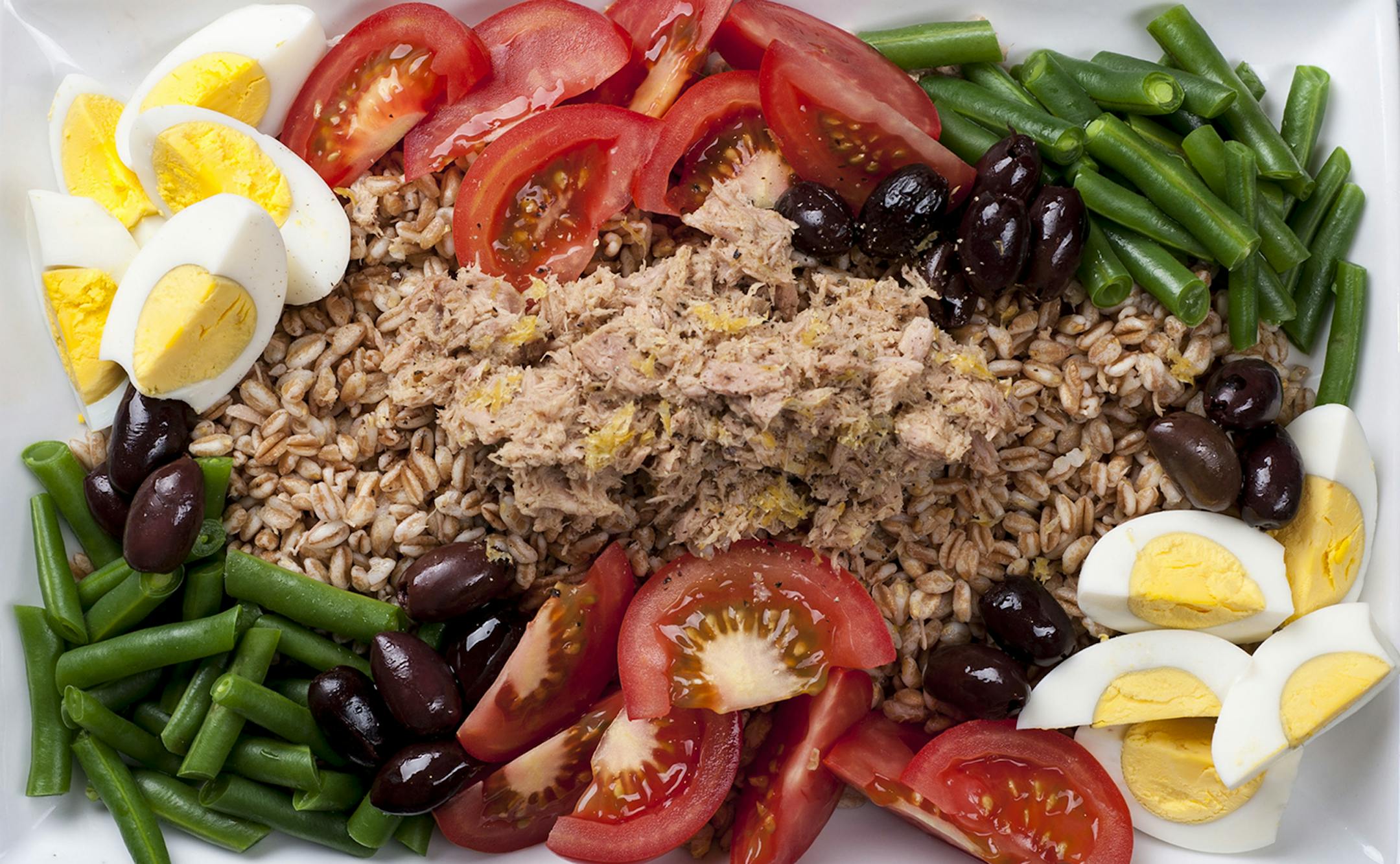 A dish of cooked farro with tuna and anchovies, in New York, July 16, 2013. The trick to making a good whole-grain dish is not letting the grain stand alone. (Karsten Moran/The New York Times) ORG XMIT: XNYT23
