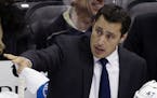 FILE - In this Feb. 24, 2013, file photo, Tampa Bay Lightning head coach Guy Boucher gives instructions from behind his bench in the first period of a