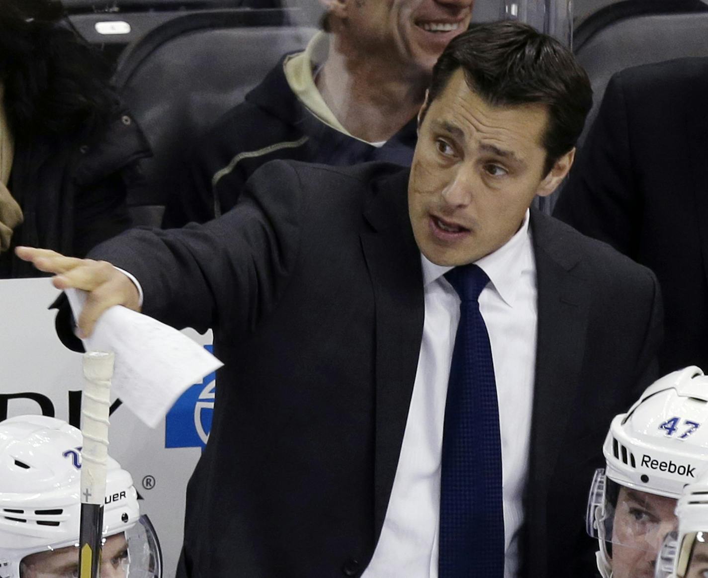 FILE - In this Feb. 24, 2013, file photo, Tampa Bay Lightning head coach Guy Boucher gives instructions from behind his bench in the first period of an NHL hockey game against the Pittsburgh Penguins in Pittsburgh. Boucher has been hired as the new head coach of the Ottawa Senators on Sunday, May 8, 2016. (AP Photo/Gene J. Puskar, File)