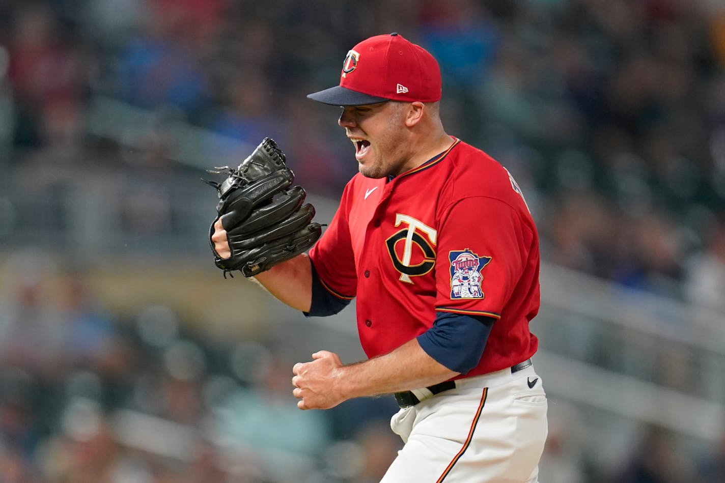 Minnesota Twins relief pitcher Caleb Thielbar celebrates after the top of the sixth inning against the Kansas City Royals in a baseball game Monday, Aug. 15, 2022, in Minneapolis. (AP Photo/Abbie Parr)