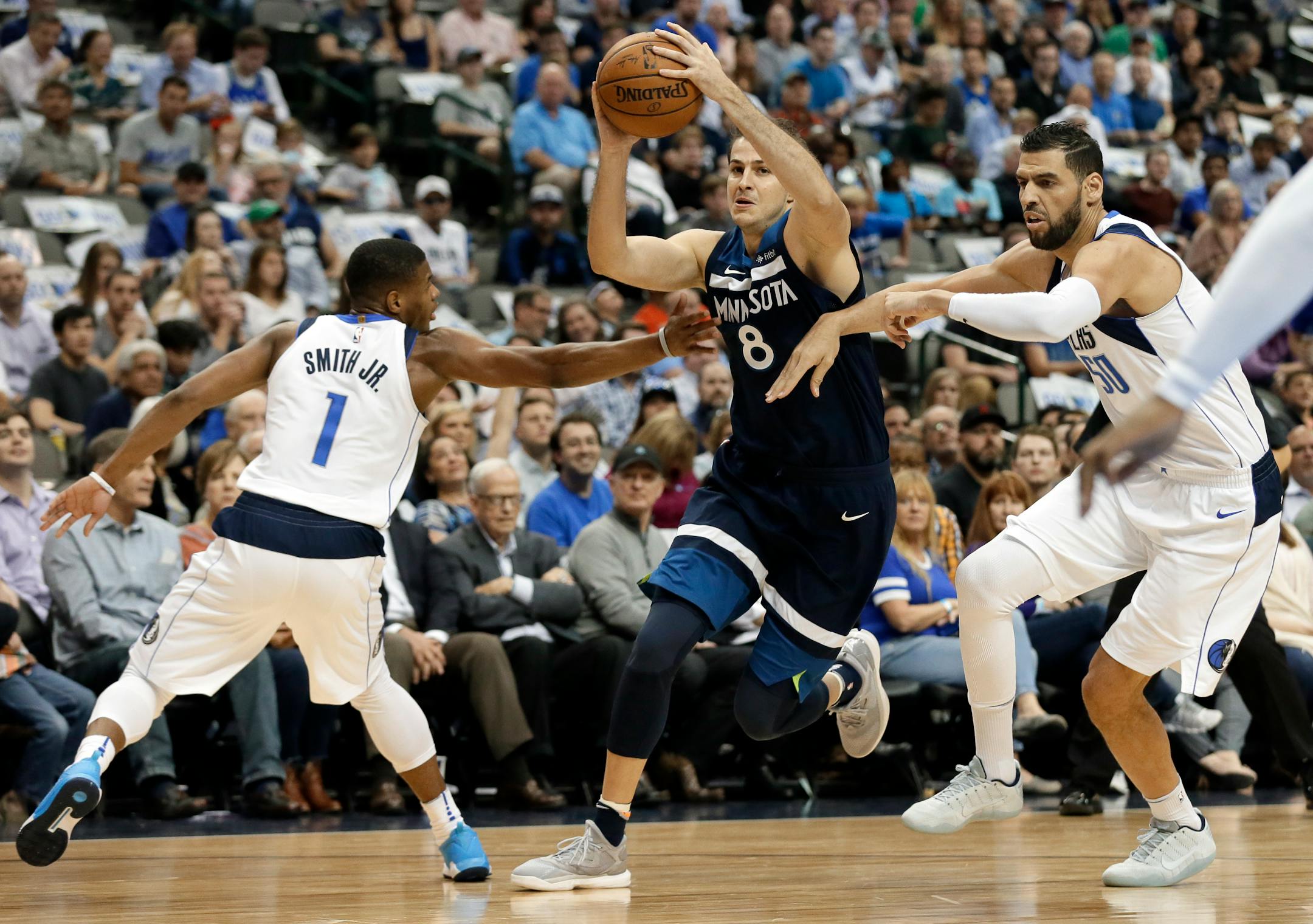 Dallas Mavericks guard Dennis Smith Jr. (1) and center Salah Mejri, right, of Tunisia, attempt to stop Minnesota Timberwolves forward Nemanja Bjelica (8), of Serbia, on a drive to the basket in the first half of an NBA basketball game, Friday, Nov. 17, 2017, in Dallas. (AP Photo/Tony Gutierrez)