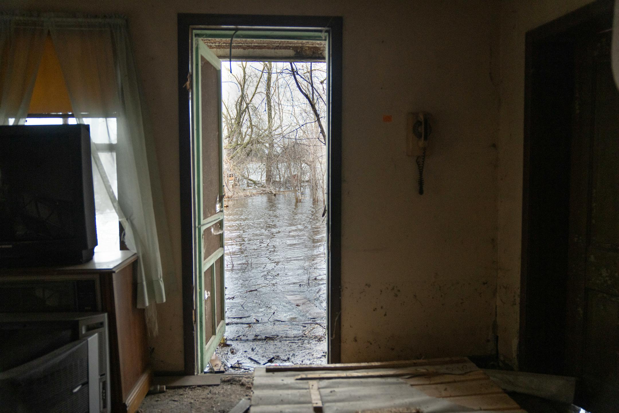 Floodwaters enter an abandoned house just off County Road 17 on Wednesday, April 19, 2023, in Delano, Minn.