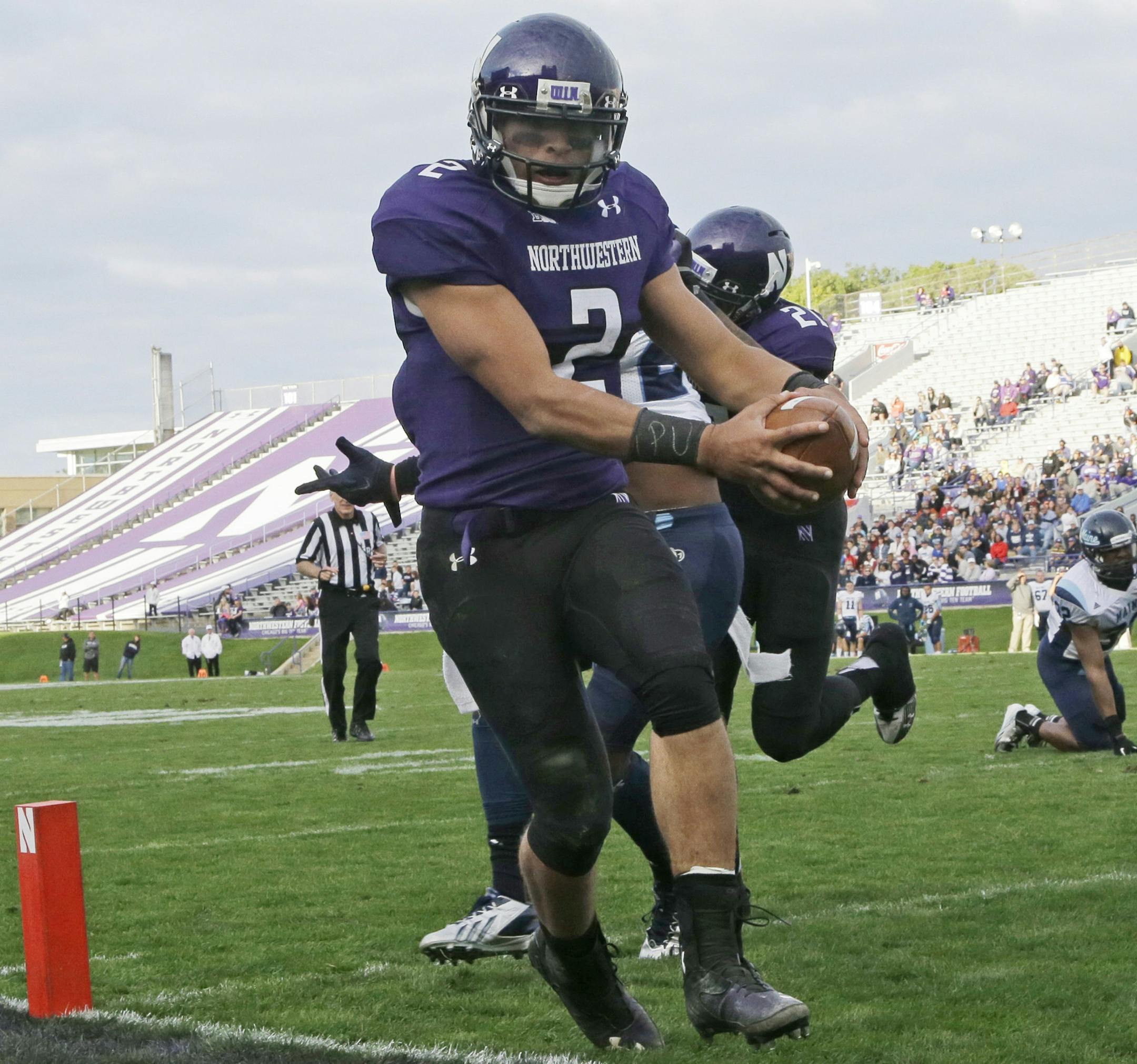 Northwestern quarterback Kain Colter (2) scores a touchdown during the second half of an NCAA college football game against Maine in Evanston, Ill., Saturday, Sept. 21, 2013. (AP Photo/Nam Y. Huh) ORG XMIT: ILNH113