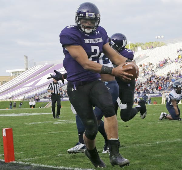 Northwestern quarterback Kain Colter (2) scores a touchdown during the second half of an NCAA college football game against Maine in Evanston, Ill., S