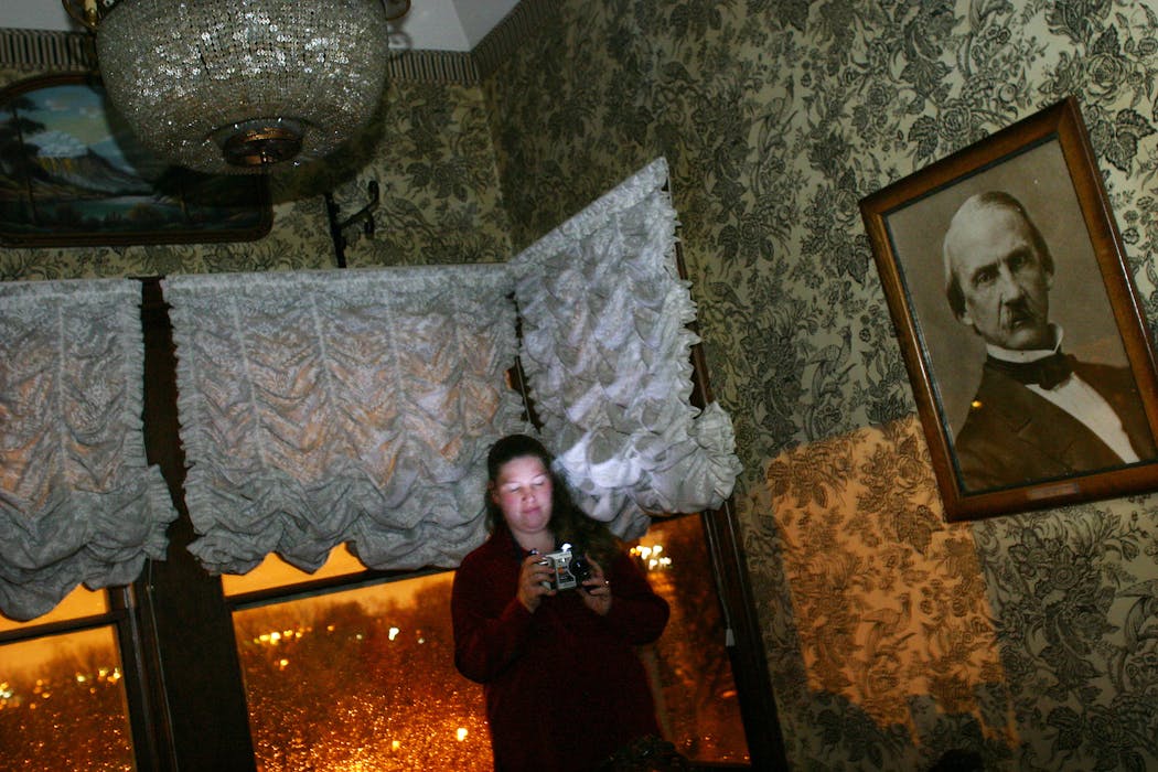 A paranormal investigator uses a digital camera to record the presence of ghosts in 2003 at Forepaugh's in St. Paul.