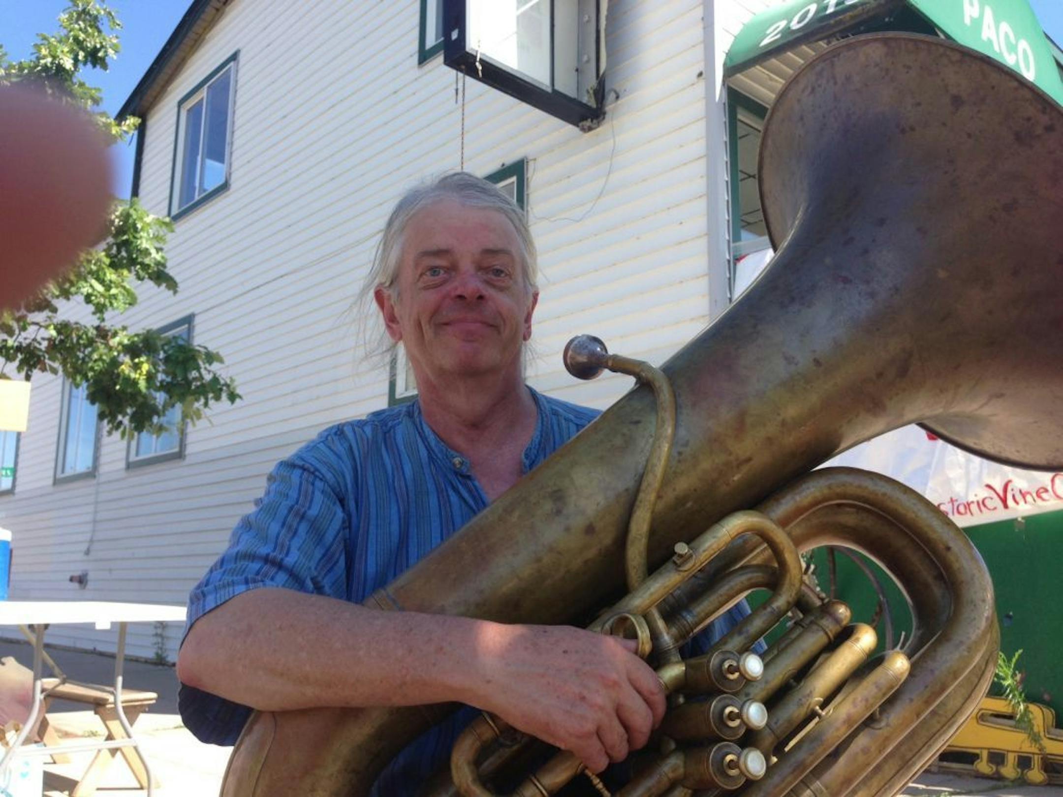 Steve Sandberg, the organizer of a campaign to save the original headquarters and factory that made Burma Shave, outside the building at 2019 E. Lake St. Various brass bands played as people were asked to sign petitions seeking a full historic survey of the building before a demolition decision.